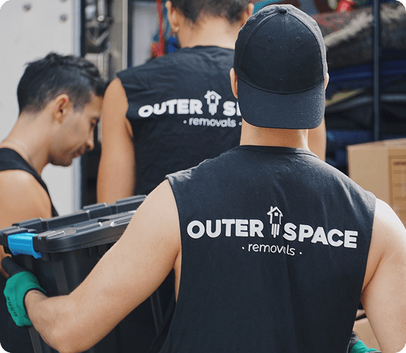 Sydney removalists carrying packed crates into a removal truck